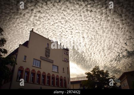 Altocumulus Clouds over Vaduz Town Hall at Sunset - Liechtenstein Stock Photo