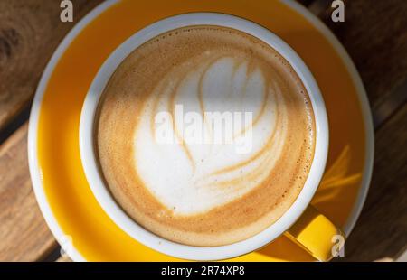 cup of cappuccino on restaurant table close up, top view Stock Photo