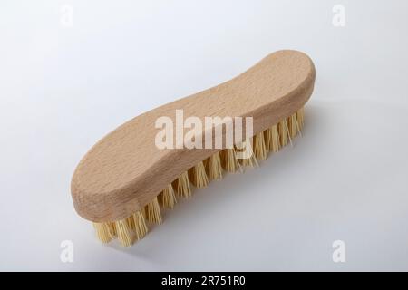 Scrub brush, S-shape, wooden handle with plastic bristles, white background, Stock Photo