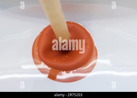 Plumber's drain cleaner tool. Rubber suction cup with wooden handle Stock  Photo - Alamy