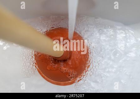 Plumber's drain cleaner tool. Rubber suction cup with wooden handle Stock  Photo - Alamy