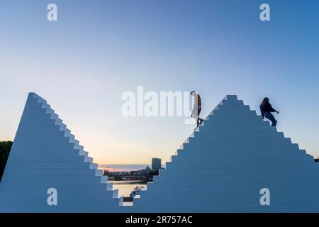 Bremen, sculpture 'Three Triangles' ('Outdoor Piece for Bremen'), by artist Sol LeWitt, persons climb on it, river Weser, Germany Stock Photo