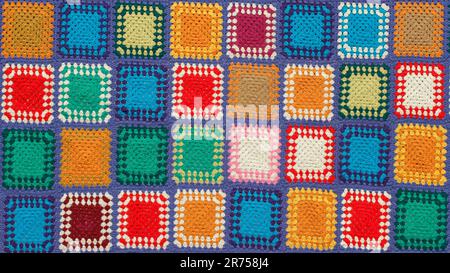 Detail of a crocheted patchwork multicolor wool blanket. Stock Photo