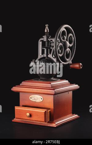 Vintage coffee grinder blender with cafe beans and aroma smoke isolated on black background Stock Photo