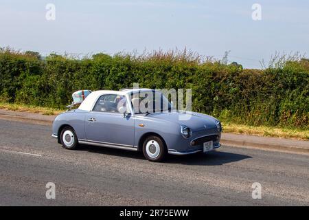 1991 90s nineties Nissan Grey Car Convertible Petrol 980 cc, retro-styled Lapis Grey Nissan Figaro;  at the Classic & Performance Motor Show at Hoghton Tower; Supercar Showtime June 2023 Stock Photo