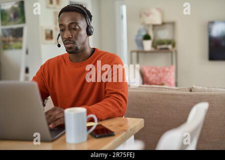 Businessman wearing a headset while working remotely from home Stock Photo