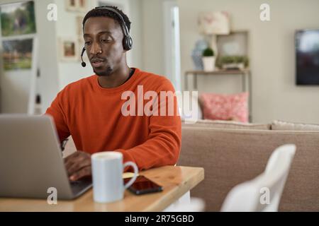 Businessman wearing a headset while working remotely from home Stock Photo