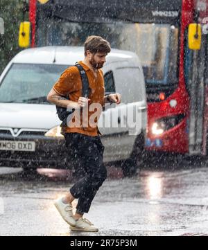 Pic shows: Flash storm hits London  Highgate sun worshippers were caught out by thunder and lightning in Highgate North London  Dress for the heatwave Stock Photo