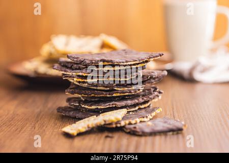 Puffed corn crackers chocolate covered on the wooden table. Stock Photo