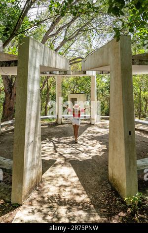 North America, Caribbean, Greater Antilles, Hispaniola Island, Dominican Republic, Sama Province, Sama Peninsula, Santa rbara de Sama, Attractive woman standing in architectural construction on Cayo Vigia in Sama Bay Stock Photo