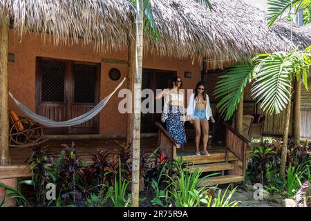 North America, Caribbean, Greater Antilles, Hispaniola Island, Dominican Republic, North Coast, Puerto Plata Province, Cabarete, Natura Cabana, Two girlfriends leave their bungalow Stock Photo