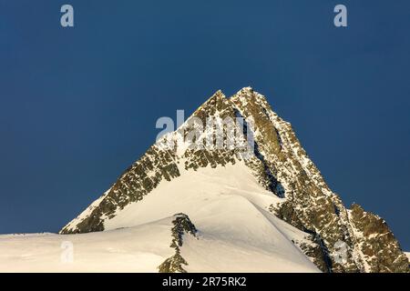 Großglockner, snow covered peak, dark blue sky Stock Photo