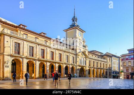 Oviedo, Asturias, Spain - February 12, 2023: Tourists and locals walk in a downtown square on a sunny day. The plaza is surrounded by city architectur Stock Photo