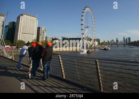 London Eye ferris wheel and County Hall, River Thames, London, England, United Kingdom - Sikh or Punjabi community - immigration Stock Photo