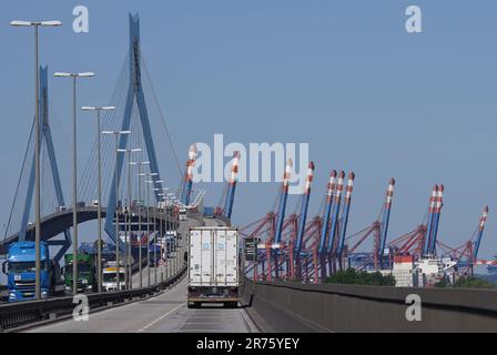 Hamburg, Germany. 13th June, 2023. Trucks drive over the Köhlbrand Bridge in the port. The container terminal bridges can be seen in the background. Hamburg's red-green senate has presented the long-awaited port development plan. The new plan, which extends to the year 2040, is intended to set the course for the future of Germany's largest port. The aim is to exploit the value creation potential for the port by setting the right course and to secure the port's success in the long term. Credit: Marcus Brandt/dpa/17�Թ����� Live News Stock Photo