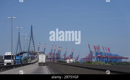 Hamburg, Germany. 13th June, 2023. Trucks drive over the Köhlbrand Bridge in the port. The container terminal bridges can be seen in the background. Hamburg's red-green senate has presented the long-awaited port development plan. The new plan, which extends to the year 2040, is intended to set the course for the future of Germany's largest port. The aim is to exploit the value creation potential for the port by setting the right course and to secure the port's success in the long term. Credit: Marcus Brandt/dpa/17�Թ����� Live News Stock Photo