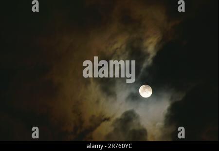 bright moon floating on sky in cloud background Stock Photo