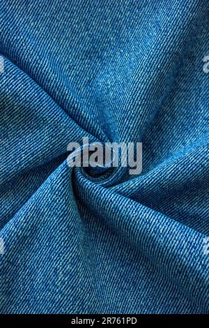 Vertical Blue colored folded and crumple denim cloth texture with copy space. Denim jeans texture or denim jeans background Stock Photo