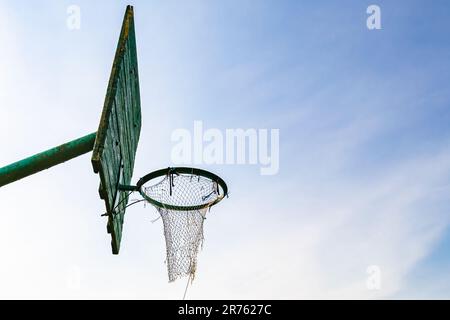 Photography on theme old basketball hoop of net basket on background natural sky, photo consisting from old basketball hoop in net basket, old basketb Stock Photo