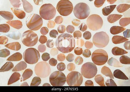 Abstract textured. Pink round mosaic with pink round mother pearl ornament, gemstone surface background, texture, close up, mock up. Stock Photo