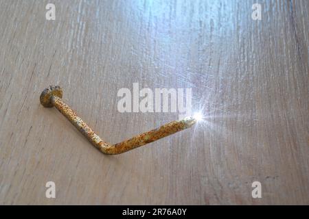Rusty old bent metal nail, computer illustration. Old nails and other dirty objects are potential source of tetanus bacteria transmitted by infected w Stock Photo