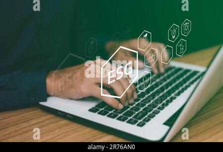 ESG environment social governance investment business concept. Women use a computer to analyze ESG, surrounded by ESG icons .close to the computer scr Stock Photo