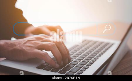 Searching Browsing Internet Data Information Networking Concept, Human hand use laptop to search the internet, Searching engine with blank search bar, Stock Photo