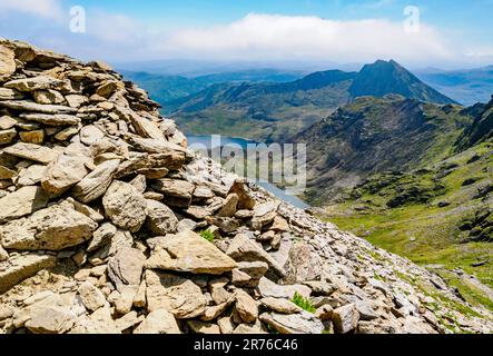 Rough screes at the top of the Pyg Track looking down to lakes Glaslyn and Llyn Llydaw on Yr Wyddfa Snowdon in the Snowdonia National Park North Wales Stock Photo