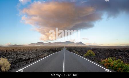 A long stright road in the Timanfaya National Park, Spain Stock Photo