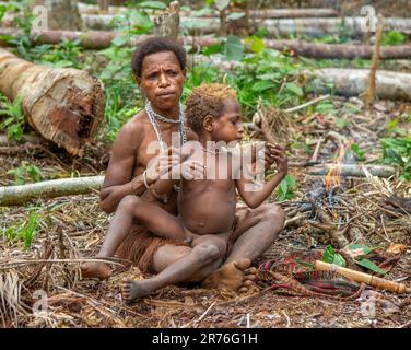 Woman of the Korovai tribe with a child. Tribe of Korowai (Kombai , Kolufo). June 10, 2016 in Onni Village, New Guinea, Indonesia Stock Photo