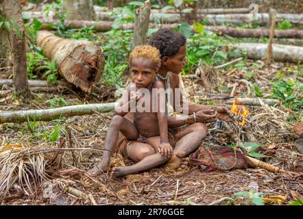 Woman of the Korovai tribe with a child. Tribe of Korowai (Kombai , Kolufo). June 10, 2016 in Onni Village, New Guinea, Indonesia Stock Photo