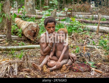 Woman of the Korovai tribe with a child. Tribe of Korowai (Kombai , Kolufo). June 10, 2016 in Onni Village, New Guinea, Indonesia Stock Photo