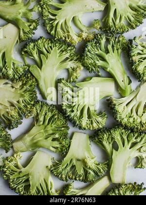 From above green broccoli stems placed on wooden background preparing to cook Stock Photo