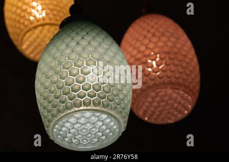 Modern chandelier with colorful glass lamp shades, close up photo with selective soft focus Stock Photo