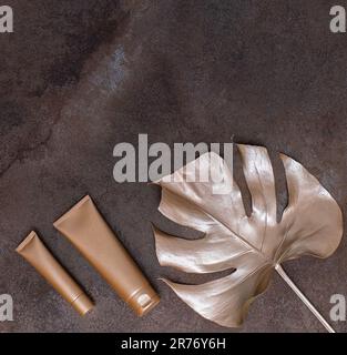 Golden palm leaf and golden bottles on the marble background. High quality photo. Stock Photo