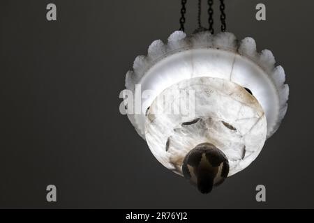 Vintage chandelier with white carved stone lamp shade, close up photo with selective focus Stock Photo