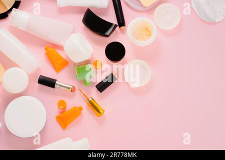 Used plastic packaging for cosmetics on a pink background. Manage waste. flat lay, top view. Stock Photo
