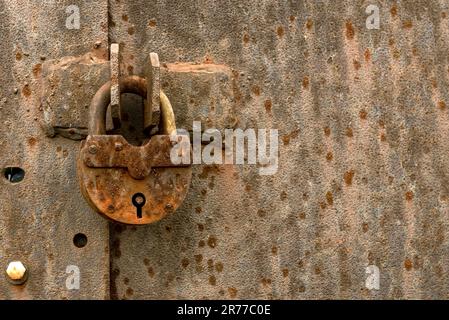 Old rusty lock on metal doors. Lock on the door with an empty place for an inscription Stock Photo