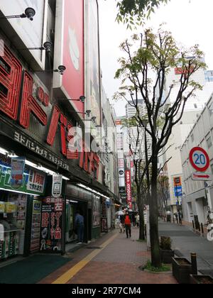 The western district around Japan's busiest station, Shinjuku, is full of busy streets with restaurants & shops. Stock Photo