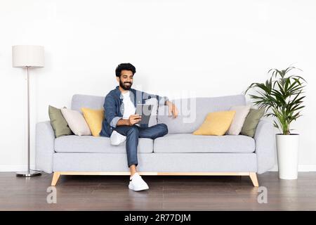 Positive arab guy have online meeting with lover, using tablet Stock Photo