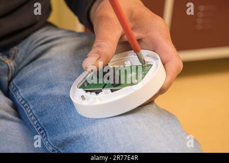 Installation of smoke on the ceiling. smoke detector in disassembled form. lower base. home security. Stock Photo
