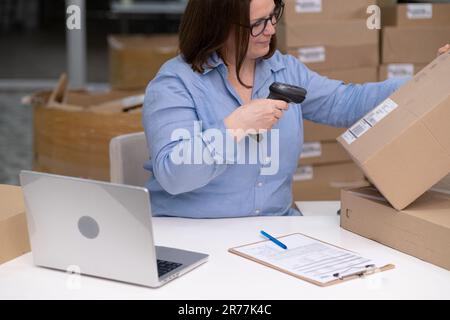 Online shop business.concept. entrepreneur using a laptop to check purchase orders manage inventory  Stock Photo