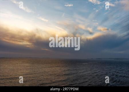 An amazing sunset of the clouds, sky and sea all coming together in a magnificent landscape over the ocean Stock Photo