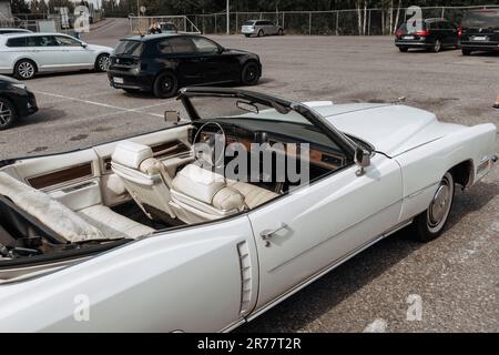 Helsinki, Finland - August 22, 2022: Classic american Cadillac car in store parking. White luxury retro vintage automobile. Stock Photo