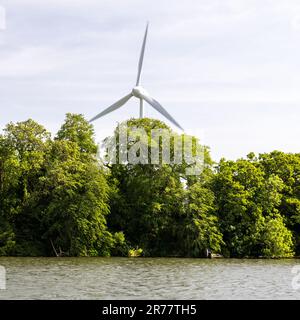 A wind turbine stands over the Gloucester and Sharpness Canal at Sharpness Docks in Gloucestershire. Stock Photo