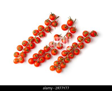 Beautiful long branches of fresh ripe cherry tomatoes on a white background top view. Organic vegetables. Cherry tomatoes isolated. Stock Photo