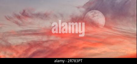 A Full Moon Is Rising In A Colorful Sunset Blue Daytime Sky Banner Stock Photo