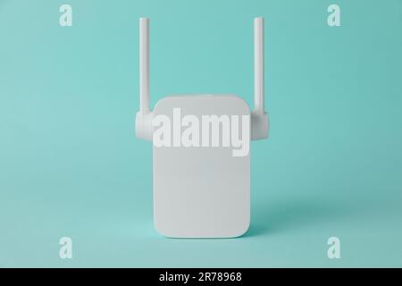 New modern Wi-Fi repeater on turquoise background Stock Photo