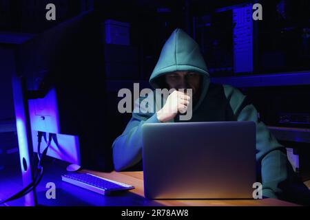 Hacker working with computers in dark room. Cyber attack Stock Photo