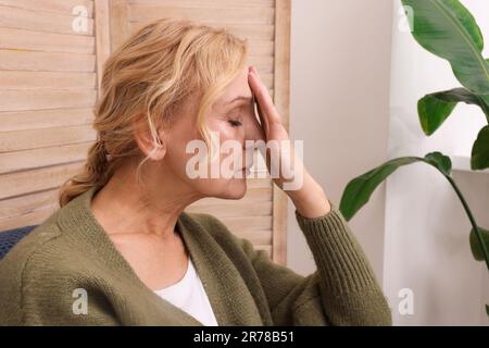 Upset middle aged woman sulking at home. Loneliness concept Stock Photo